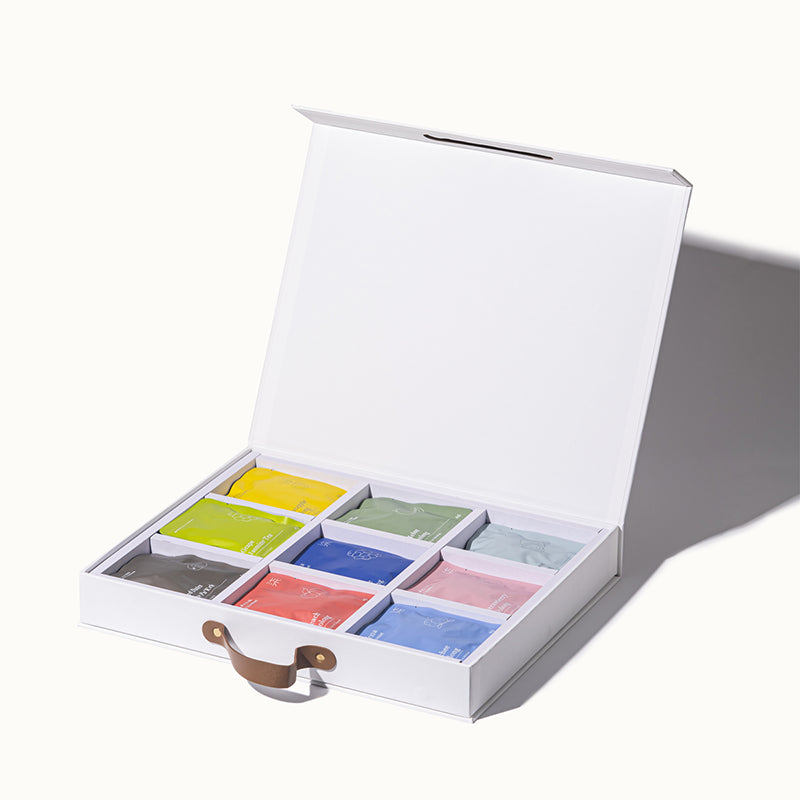White tea box with colorful tea bags on a white background