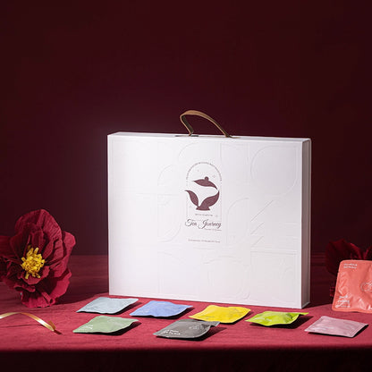 Tea packaging set with colorful tea bags on a red surface and white box in the background